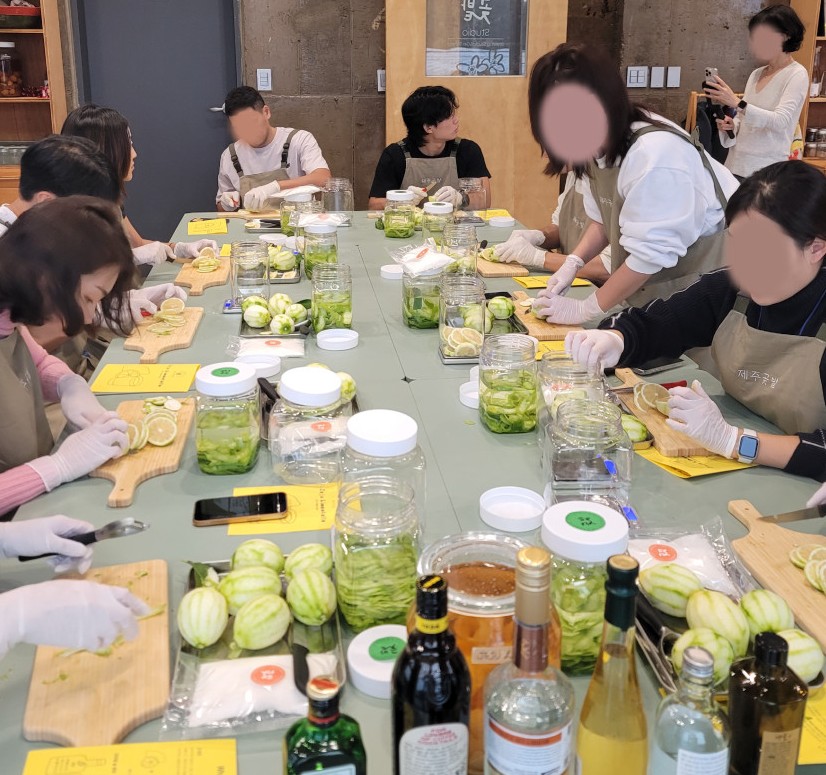 Guests making Jeju lemon liqueur together at a workshop table