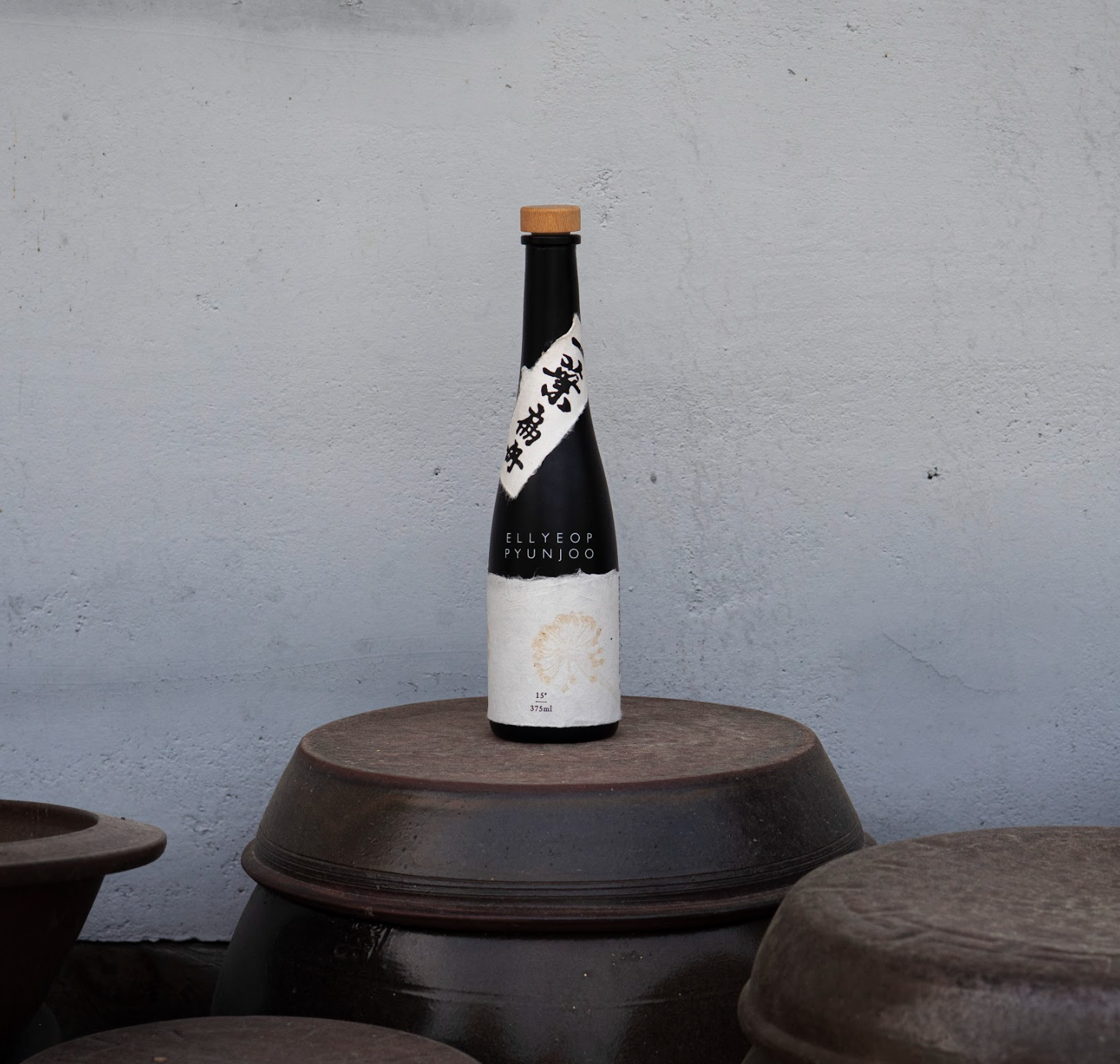 Elegant bottle of traditional Korean sool on onggi jars in Andong