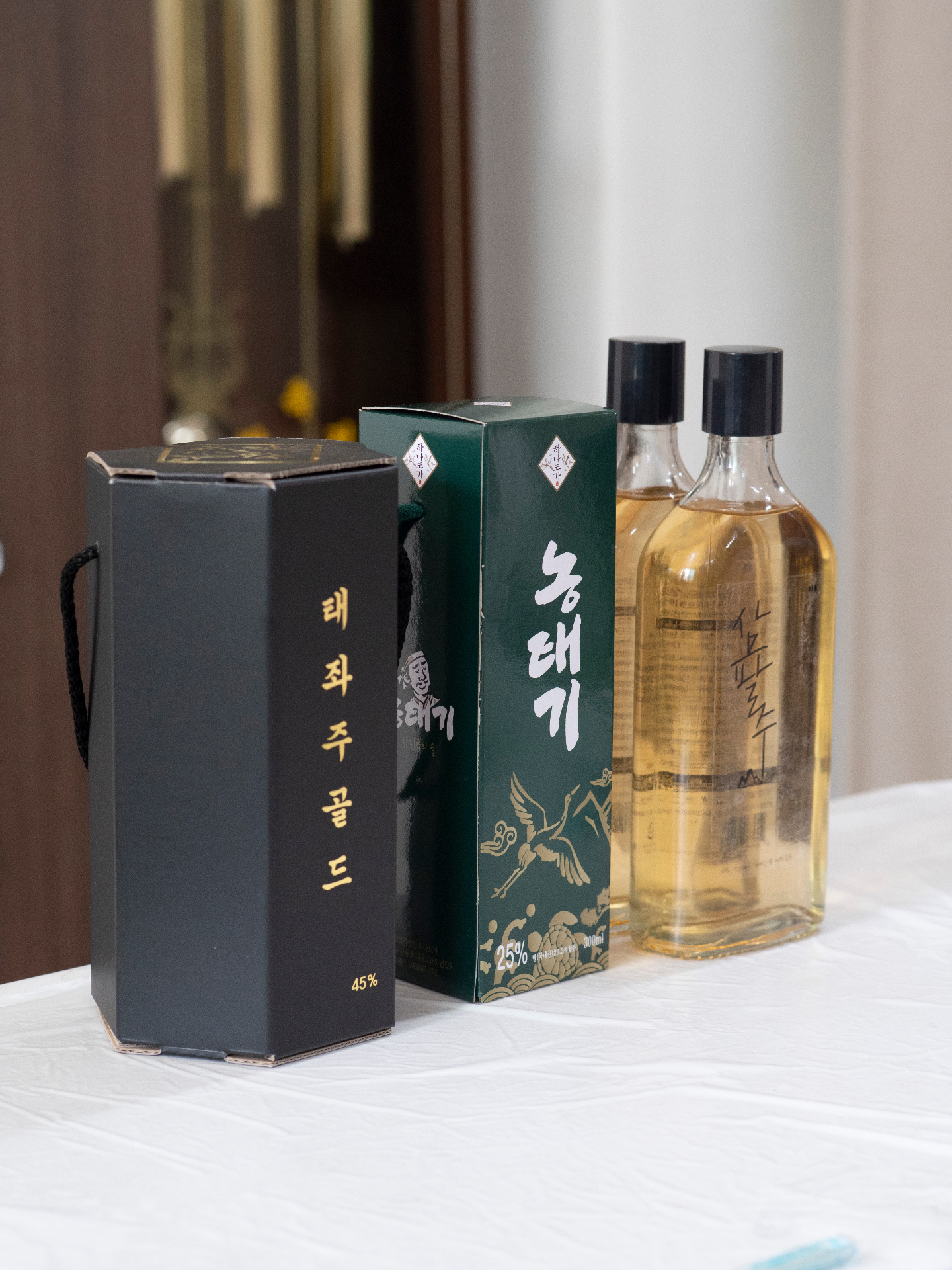 Premium Korean traditional alcohol bottles with elegant presentation boxes showcasing craft sool collection in Chungbuk
