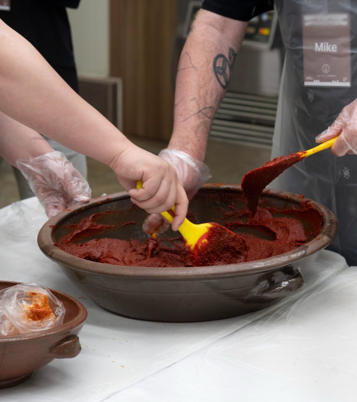 Guests stirring gochujang during hands-on workshop