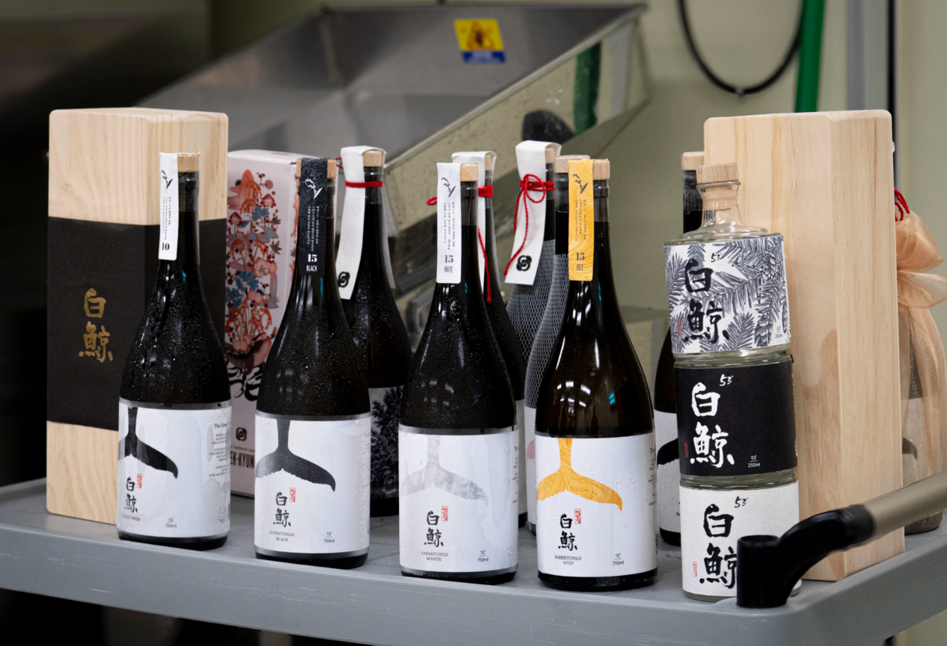 Collection of premium Korean traditional alcohol bottles with artistic labels and wooden presentation boxes