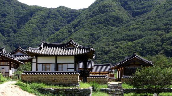 Traditional hanok village nestled in green mountains — Andong